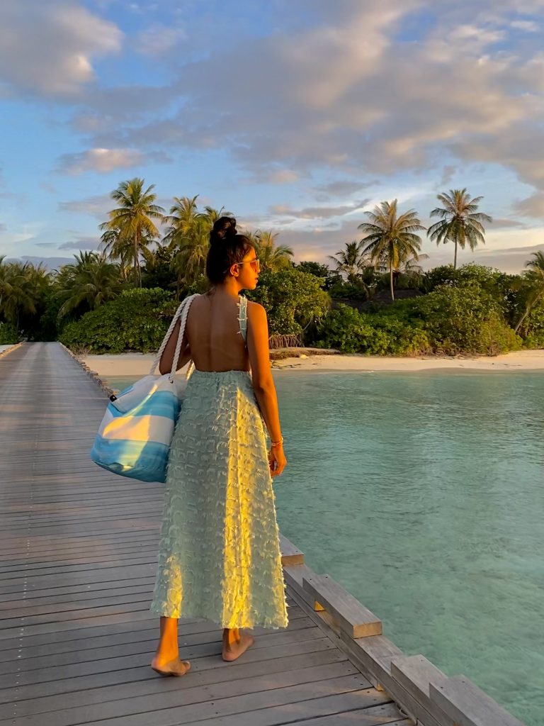 A girl in a beautiful backless dress in Maldives