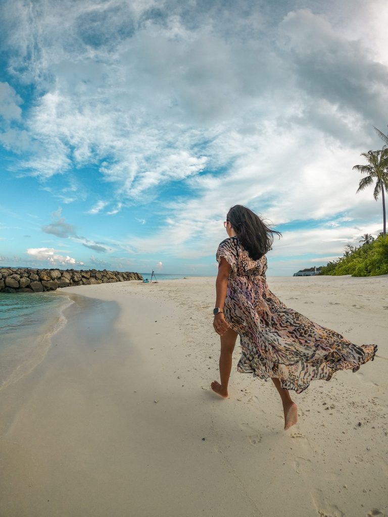 A girl in a beautiful flowy kimono on the beach