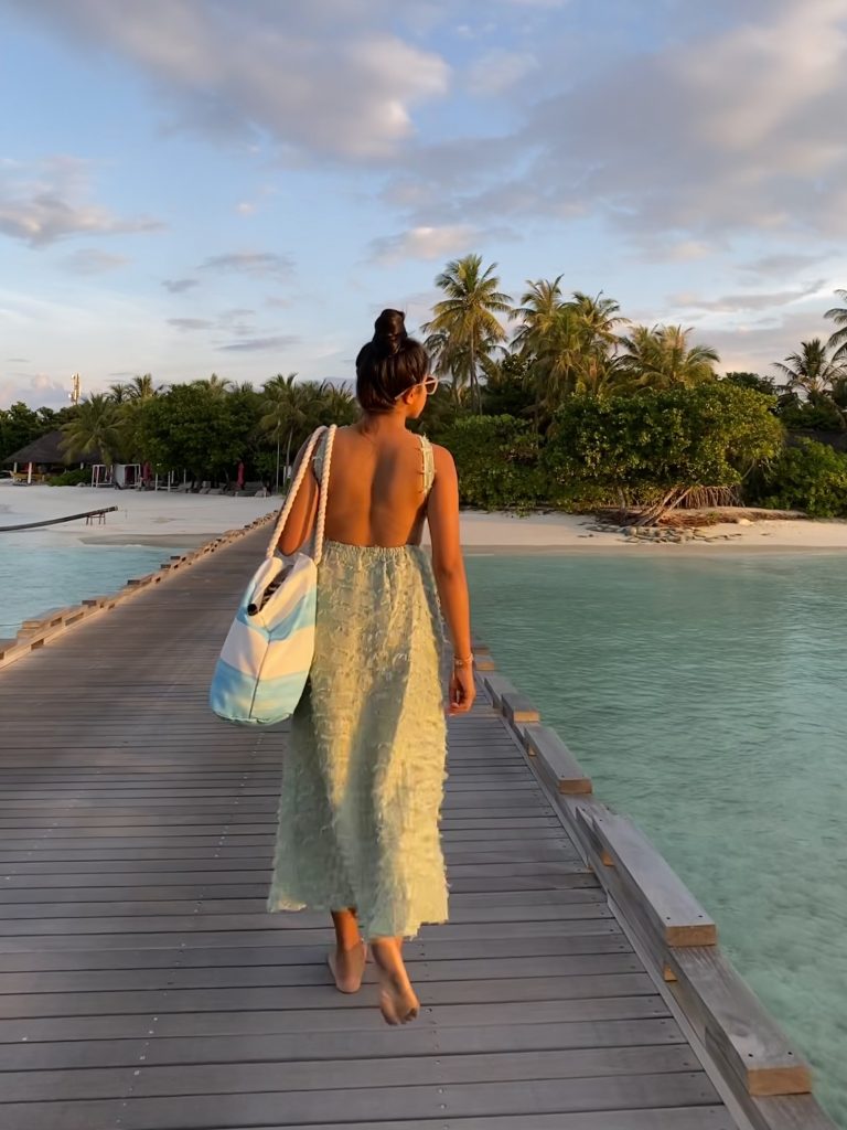 A girl in a beautiful backless dress in Maldives